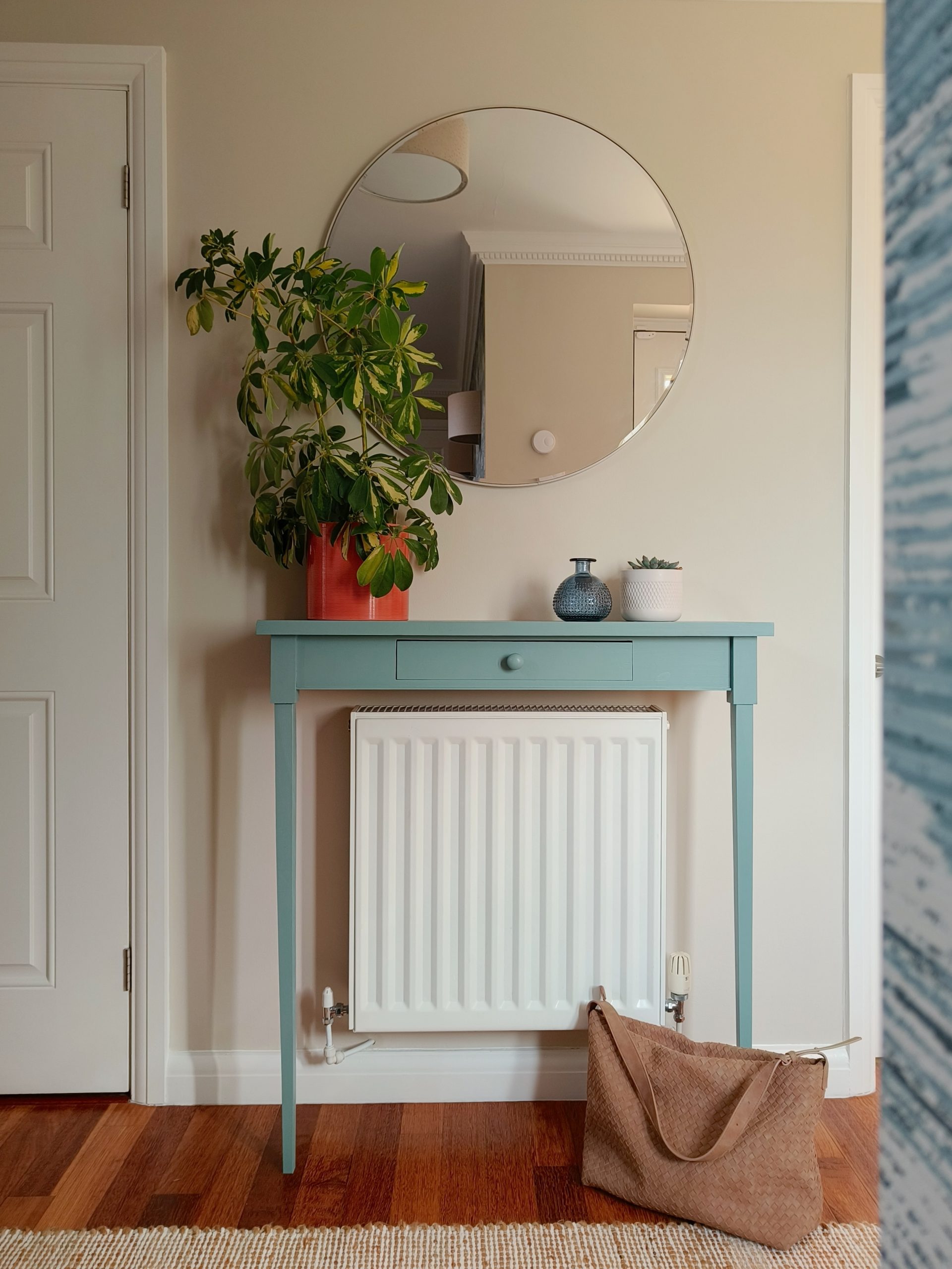 Blue radiator console in calming neutral hallway