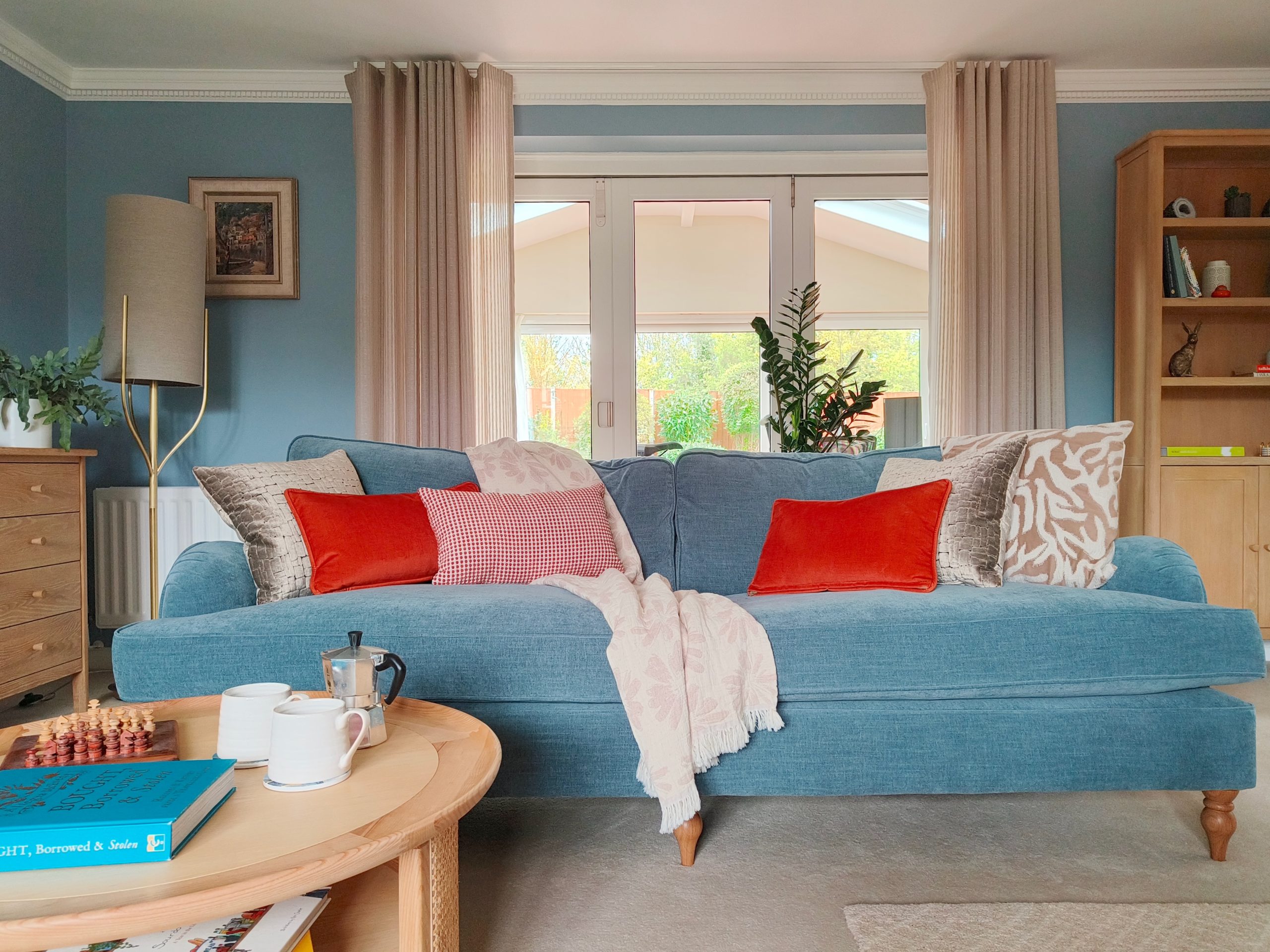 Calming modern blue living room with orange accents