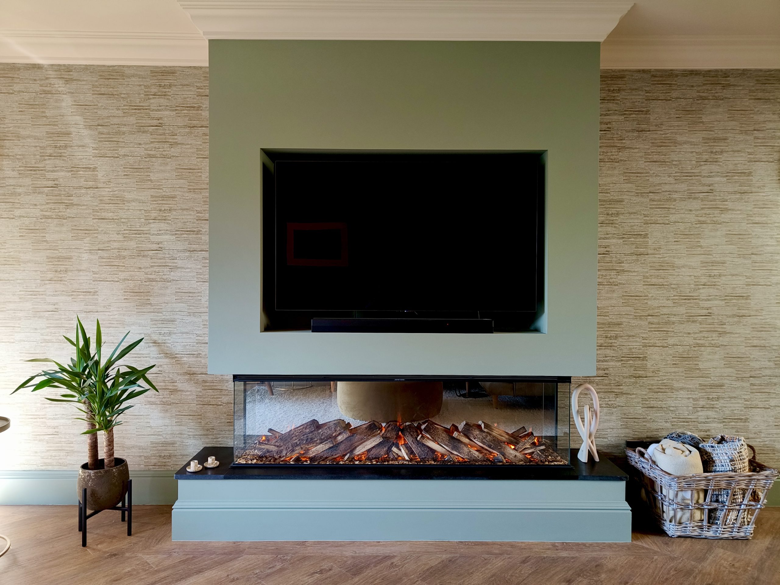 Media unit with fire under and textured wallpaper either side
