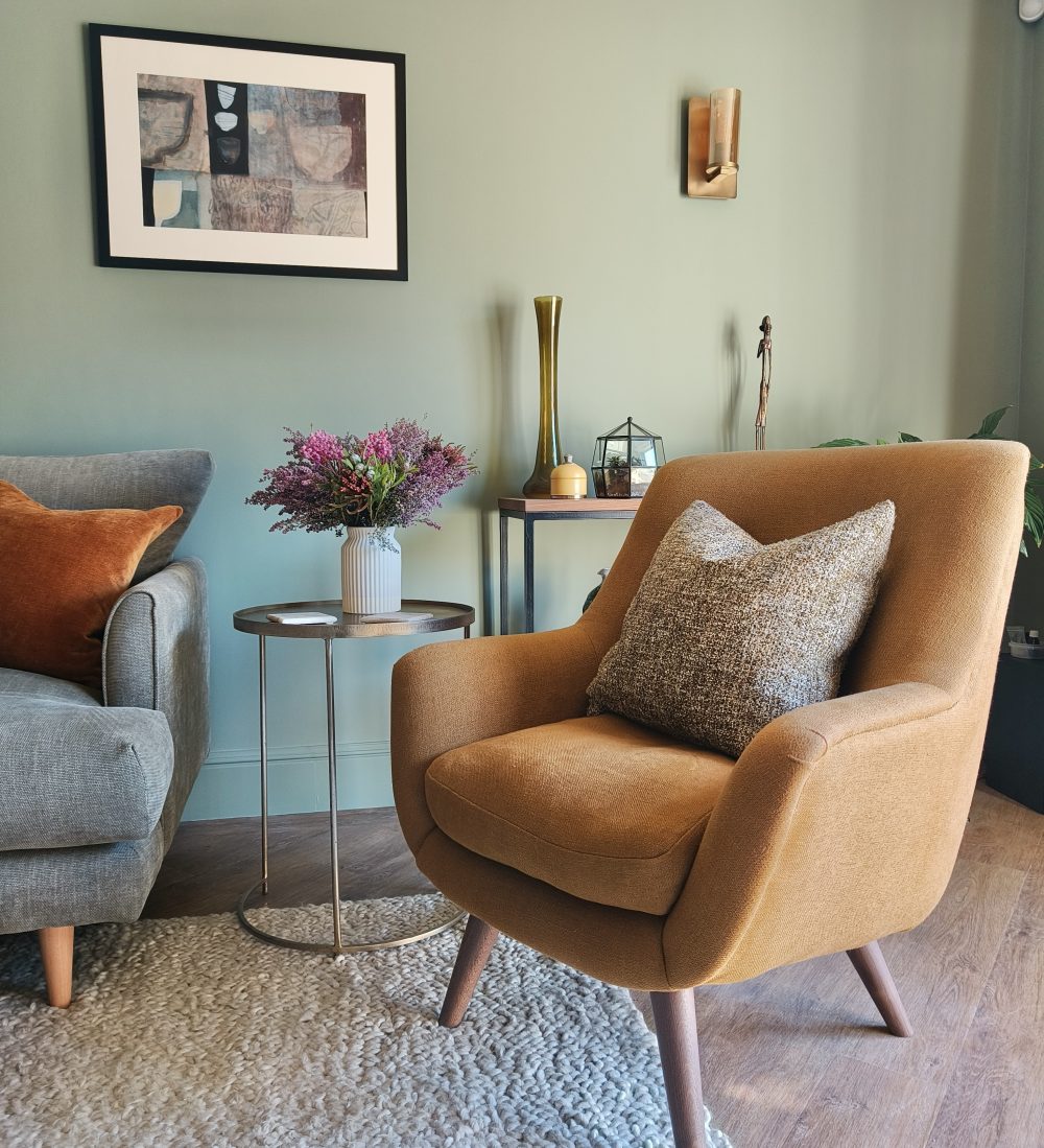 Yellow accent chair in green living room