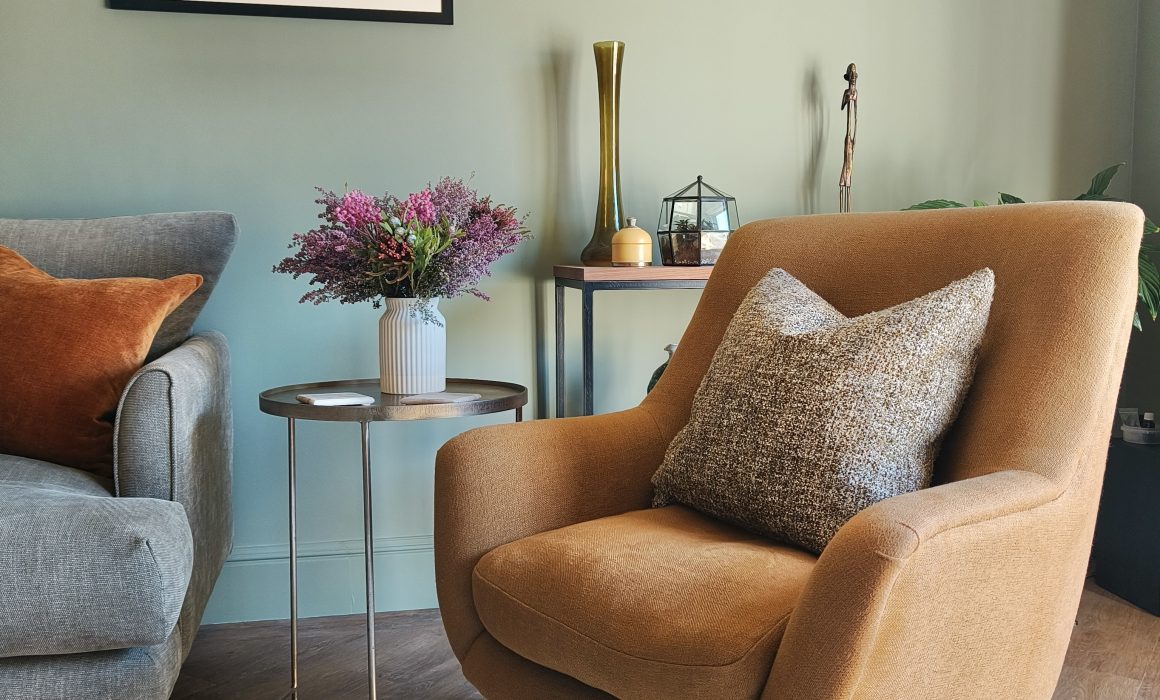 Yellow accent chair in green living room