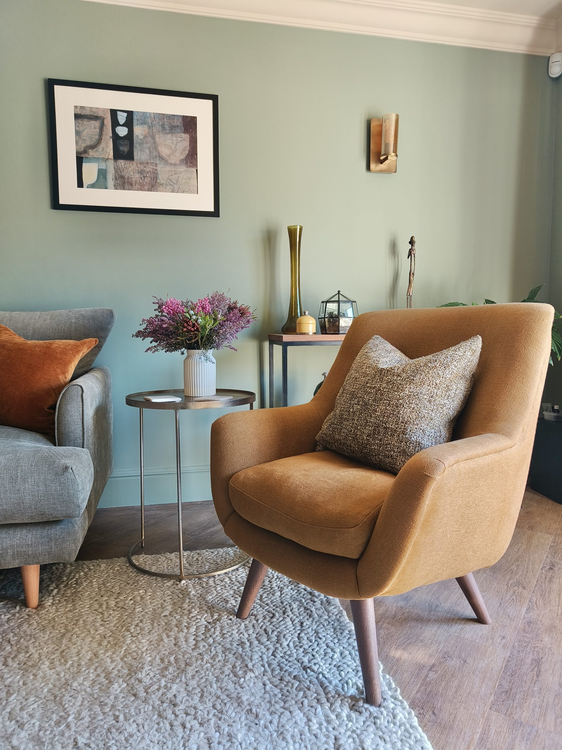 Yellow accent chair in green living room