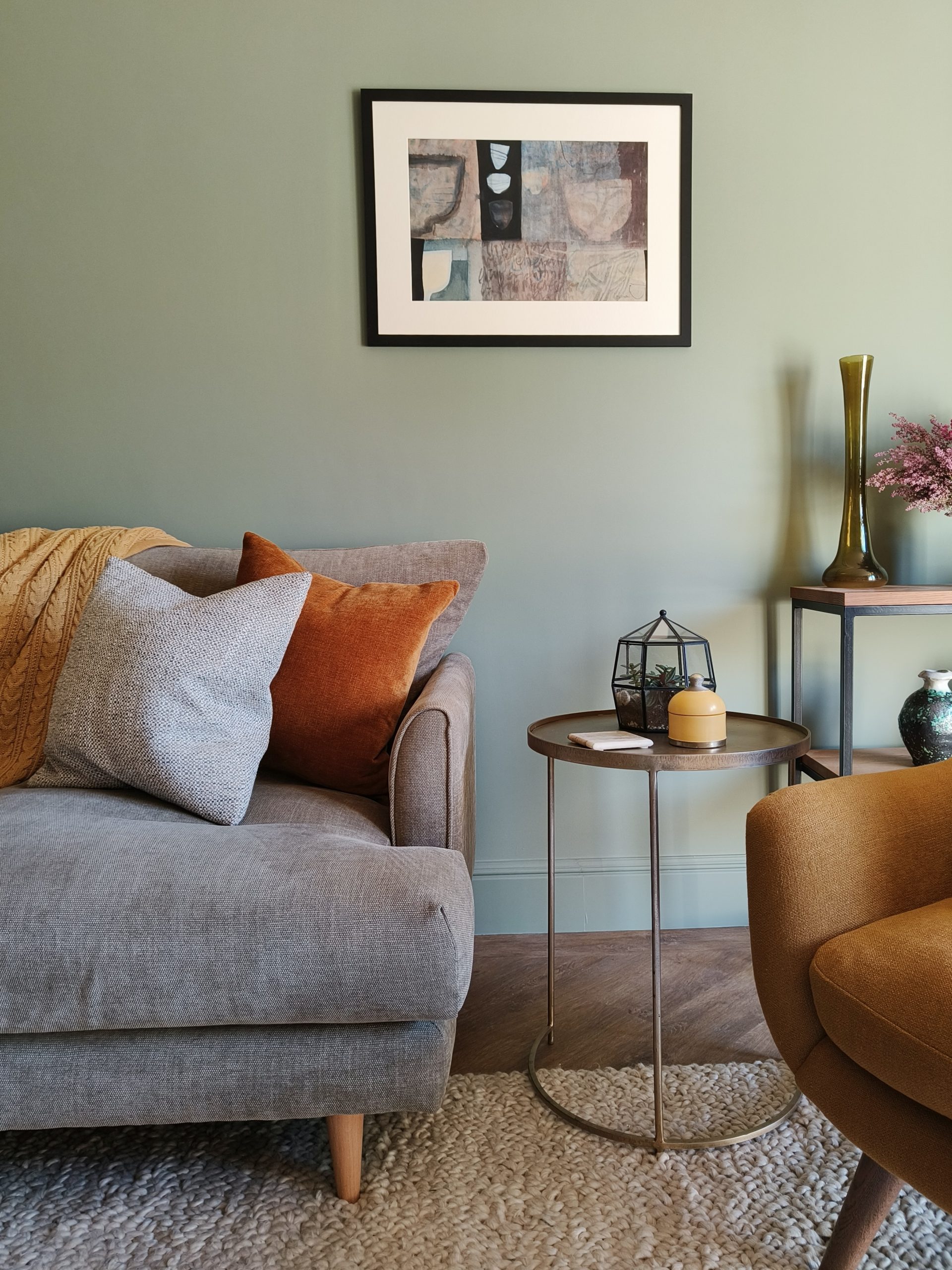 Olive sofa with rust cushion
