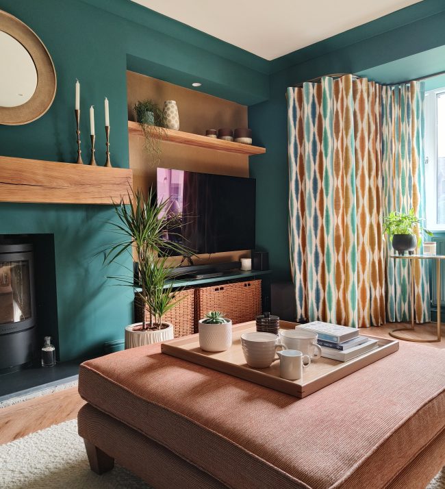 Teal living room with terracotta footstool and oak mantel