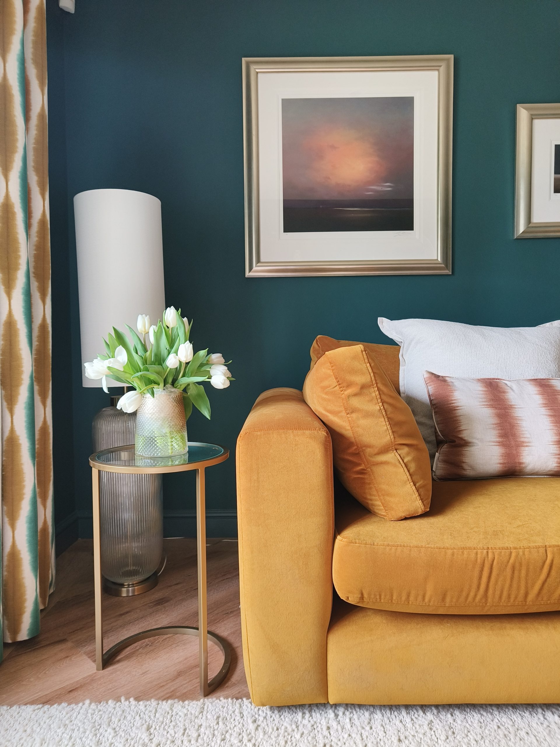 Mustard sofa in teal living room with rust accents