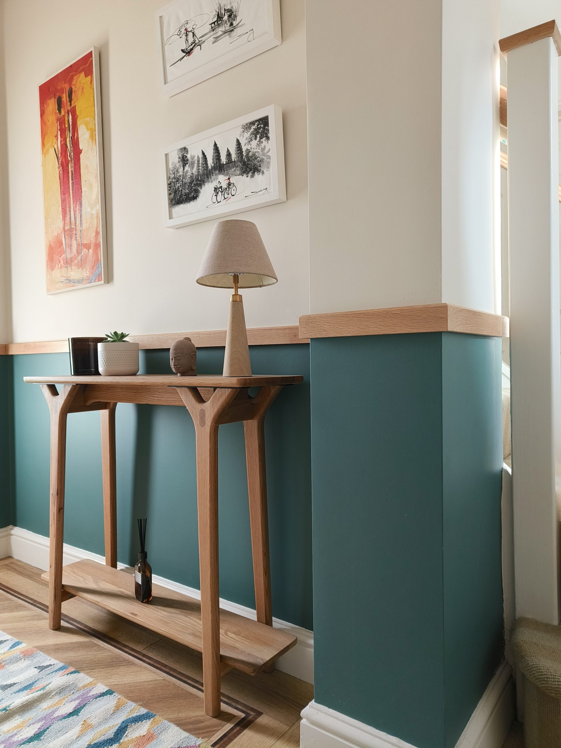 Teal and oak hallway with console