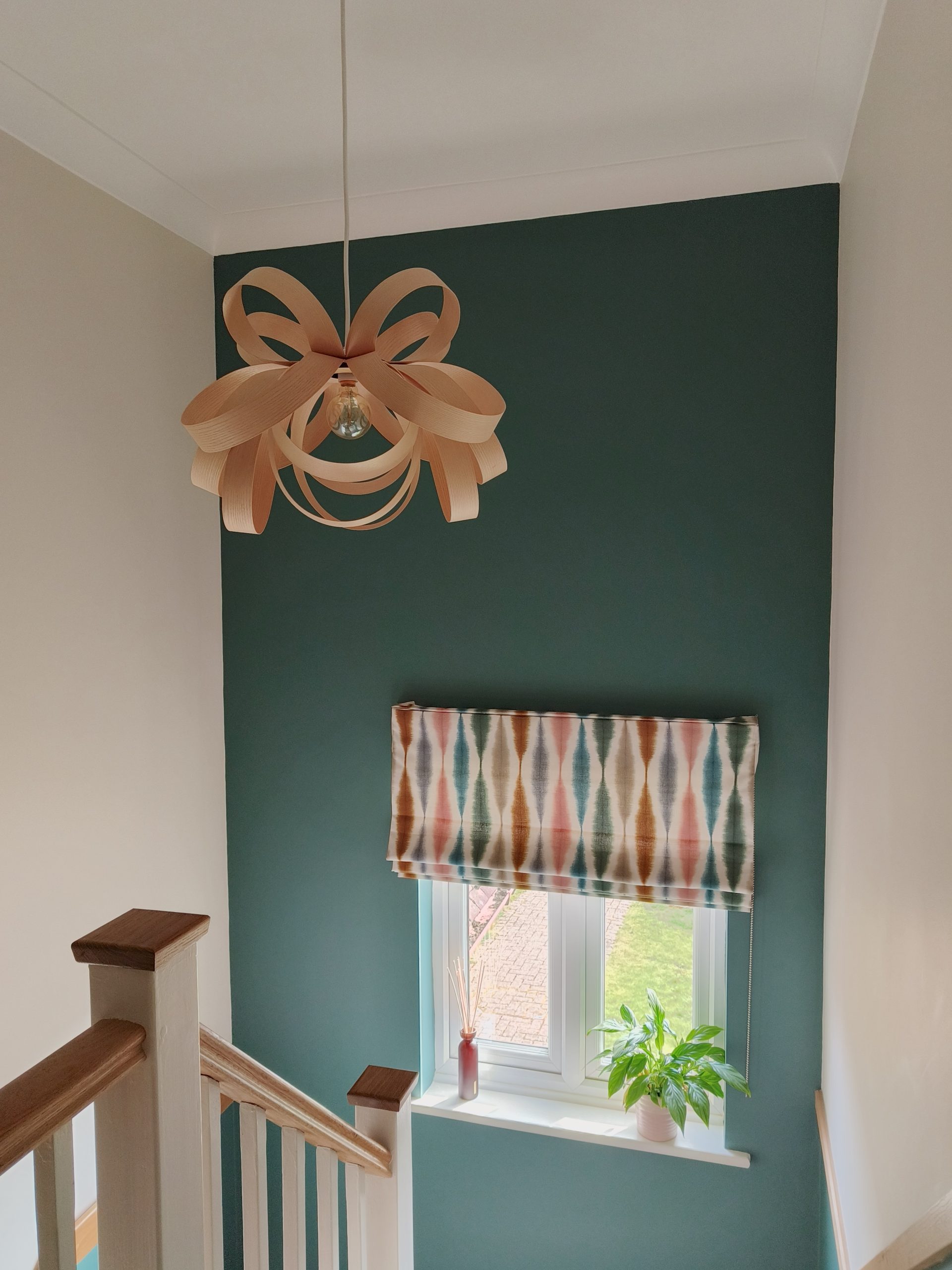 Teal hallway with statement Tom Raffield pendant
